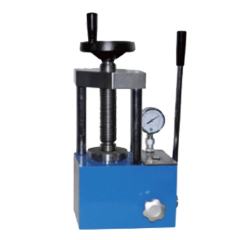 Hand-operated tablet press forming a powder pellet in a laboratory